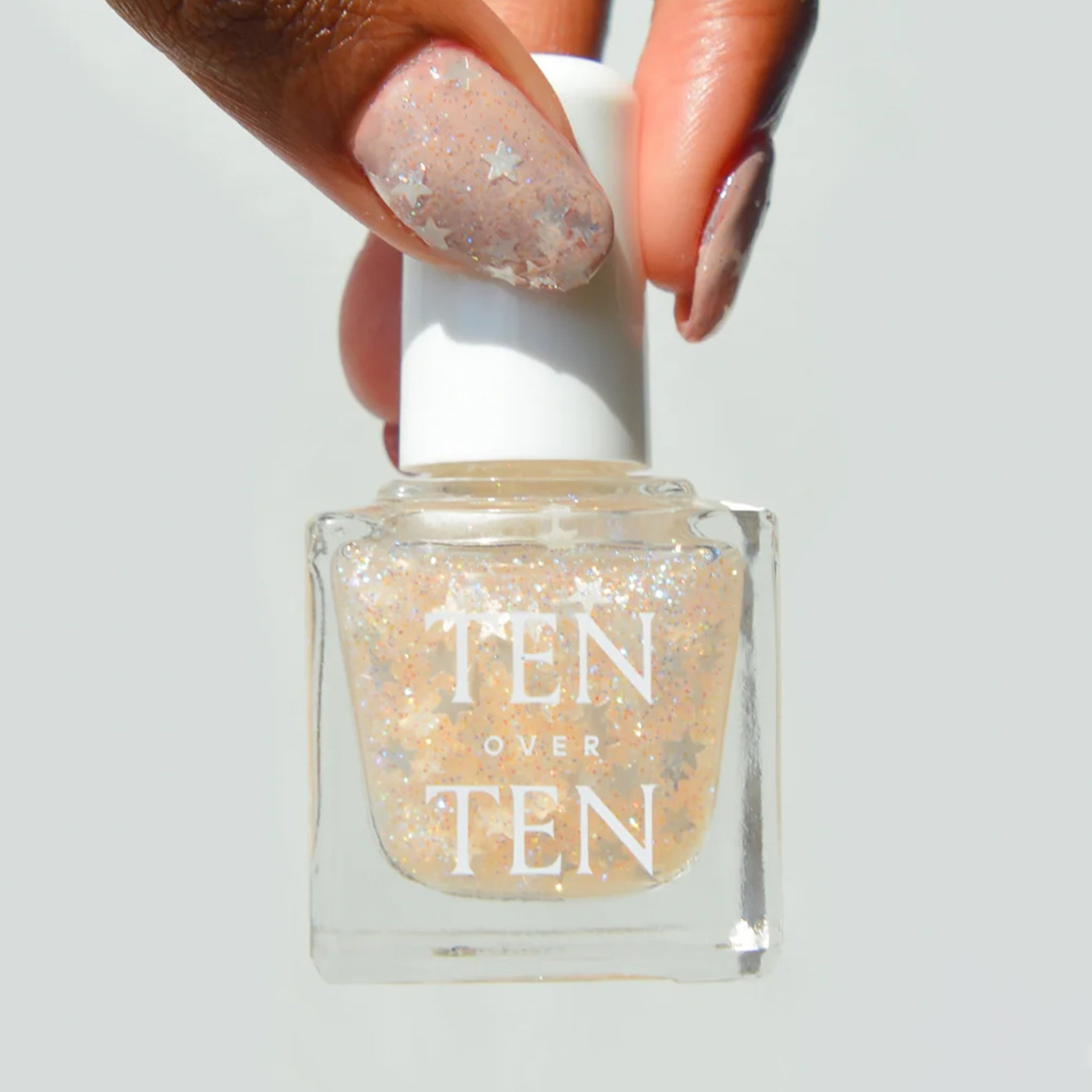 A sheer glitter nail polish with star glitter pieces.