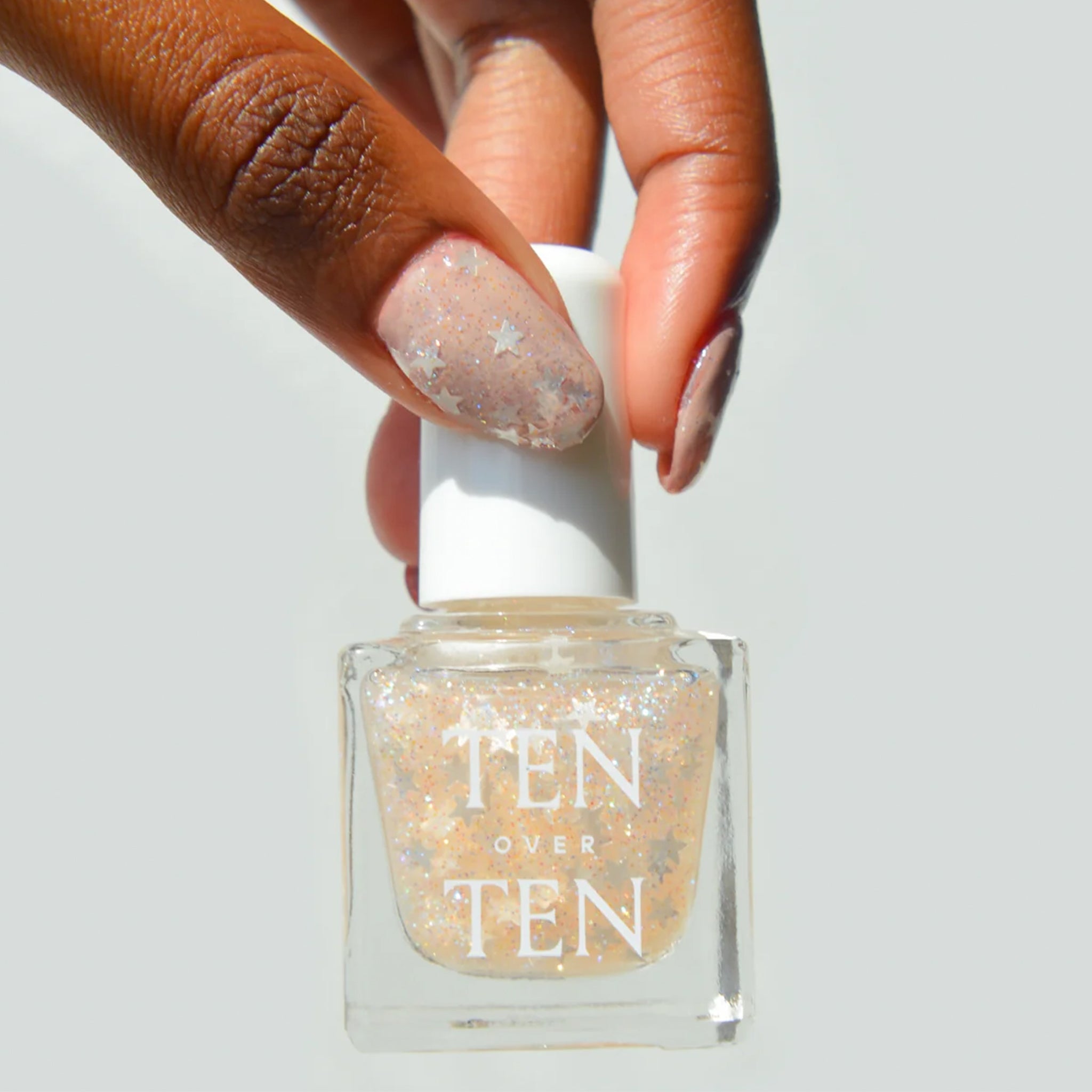 A sheer glitter nail polish with star glitter pieces. 