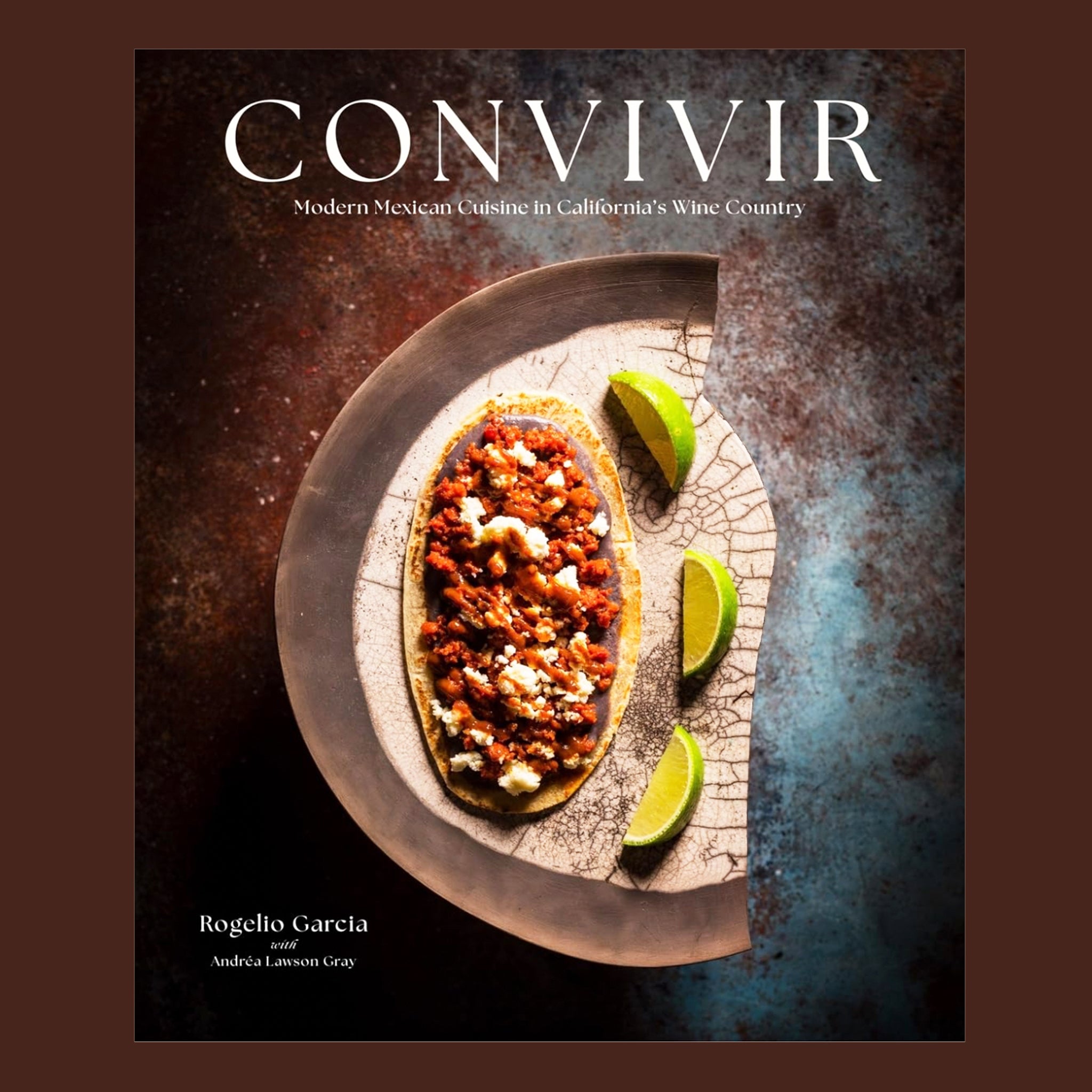 A black, brown and blue book cover with a plate of Mexican cuisine and white text above that reads, 'Convivir'.  