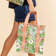 A green, white and coral floral printed cooler bag. 