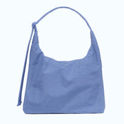 A blue nylon shoulder bag with an adjustable strap. 