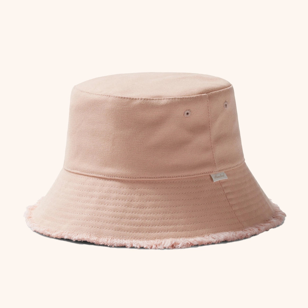 On a white background is a light pink bucket hat with a soft frayed edge.