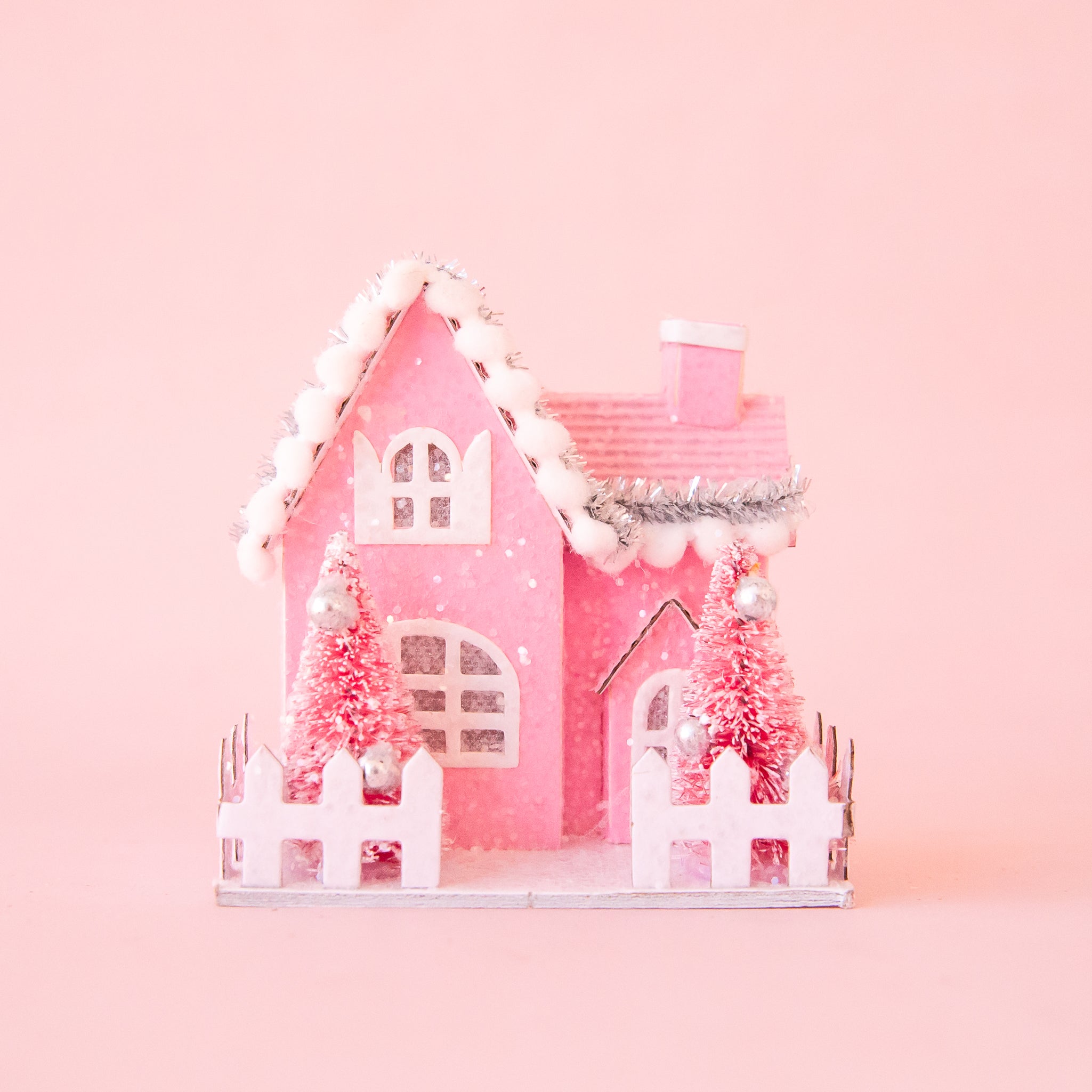 A pink cottage shaped ornament. 