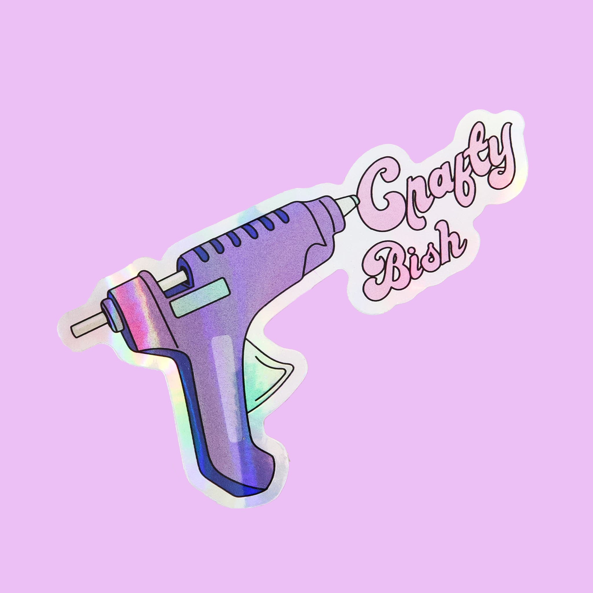 A purple sticker in the shape of a hot glue gun with words coming out of the tip that say, "Crafty Bish" in light pink letters.