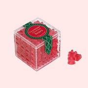 An acrylic box filled with red bear shaped gummy candies. 