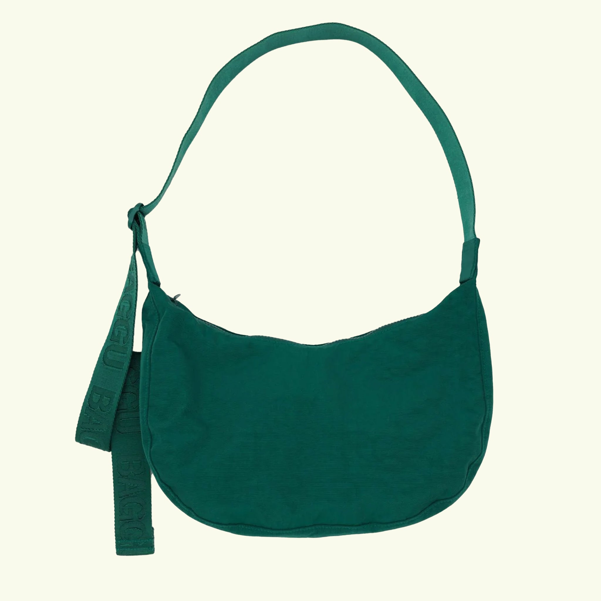 A dark green nylon handbag with a adjustable strap.