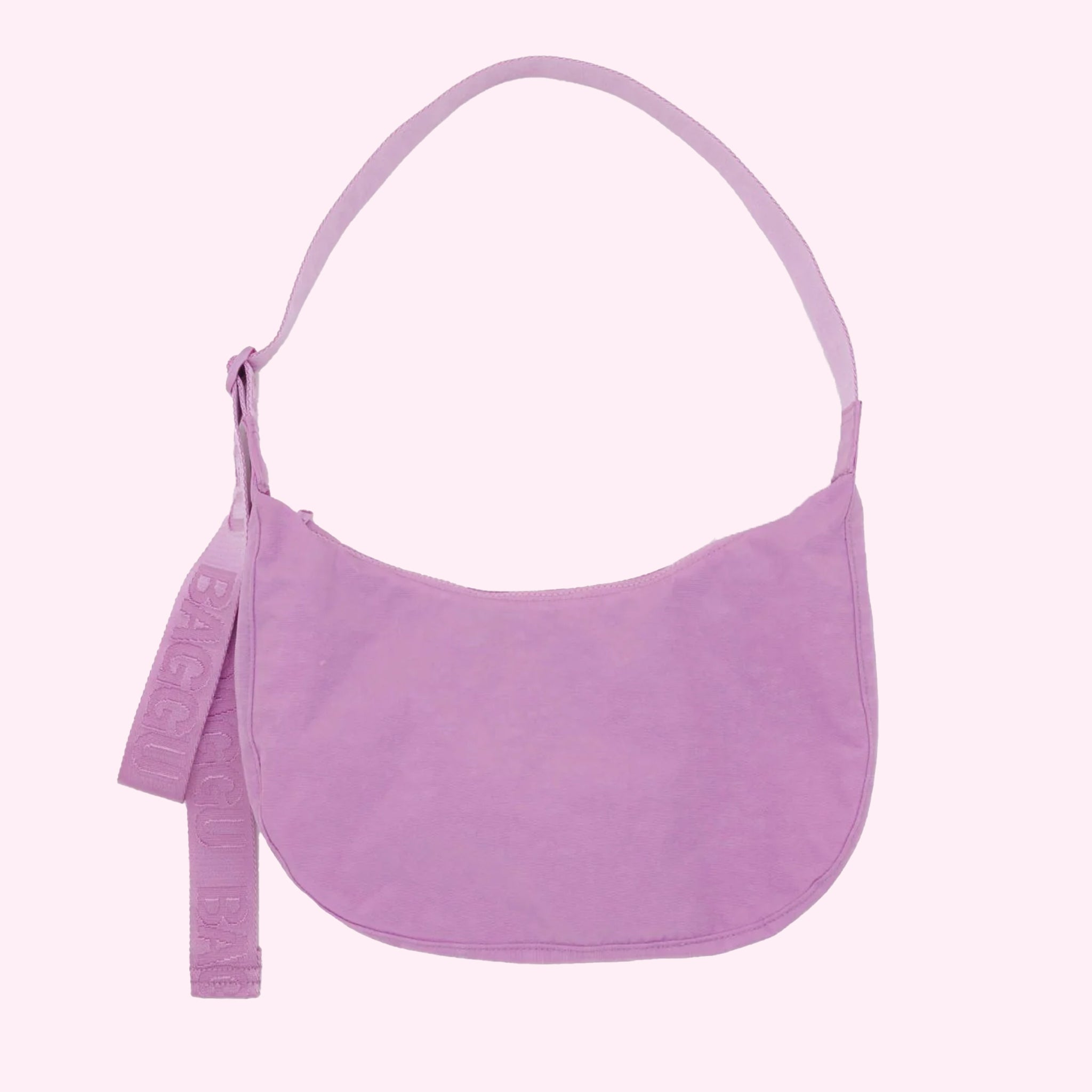 A pinkish purple crescent shaped nylon handbag with an adjustable strap. 