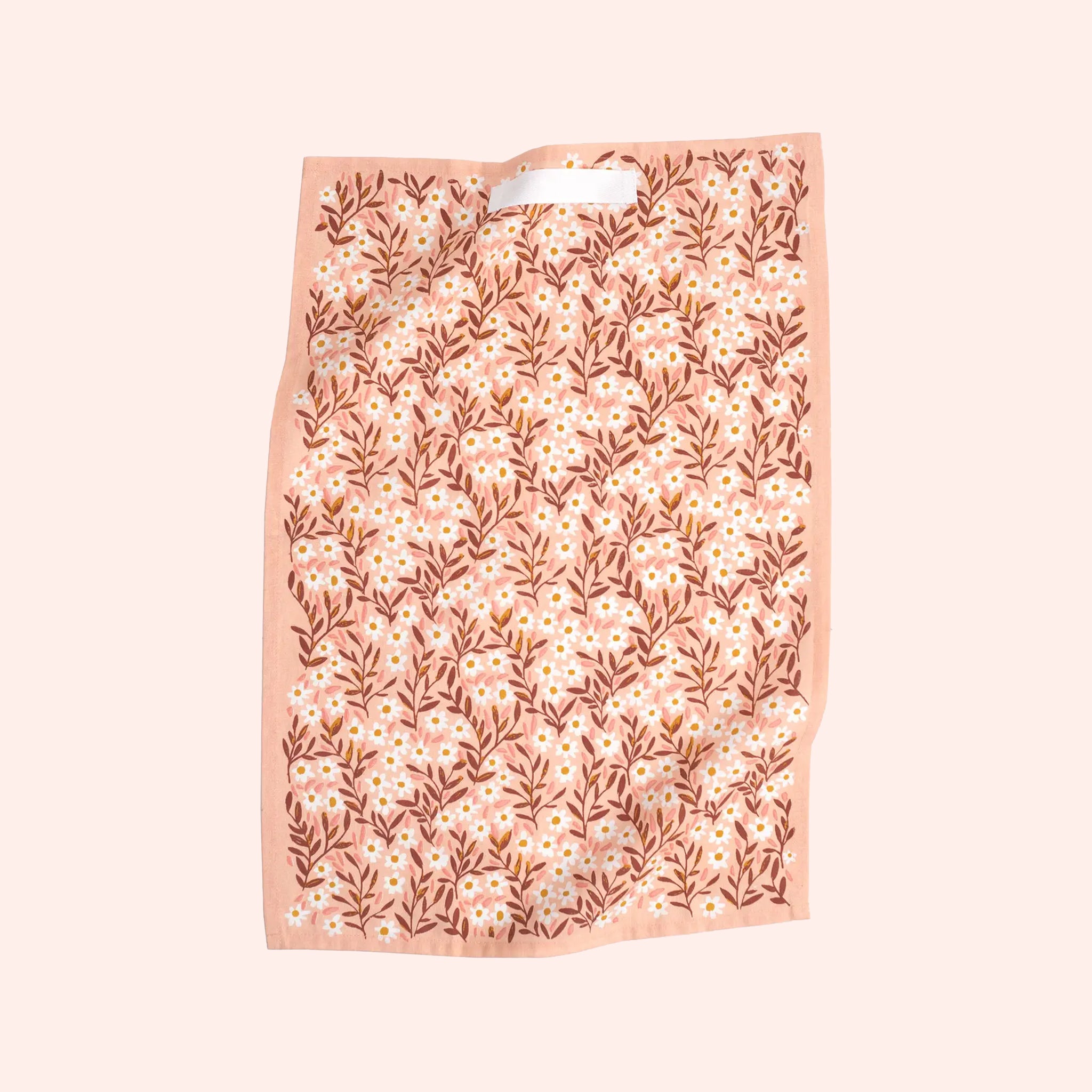 A pink floral print kitchen towel with a loop at the top for hanging. 