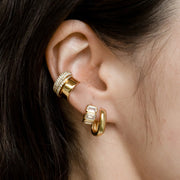 A gold pair of oblong hoops. 