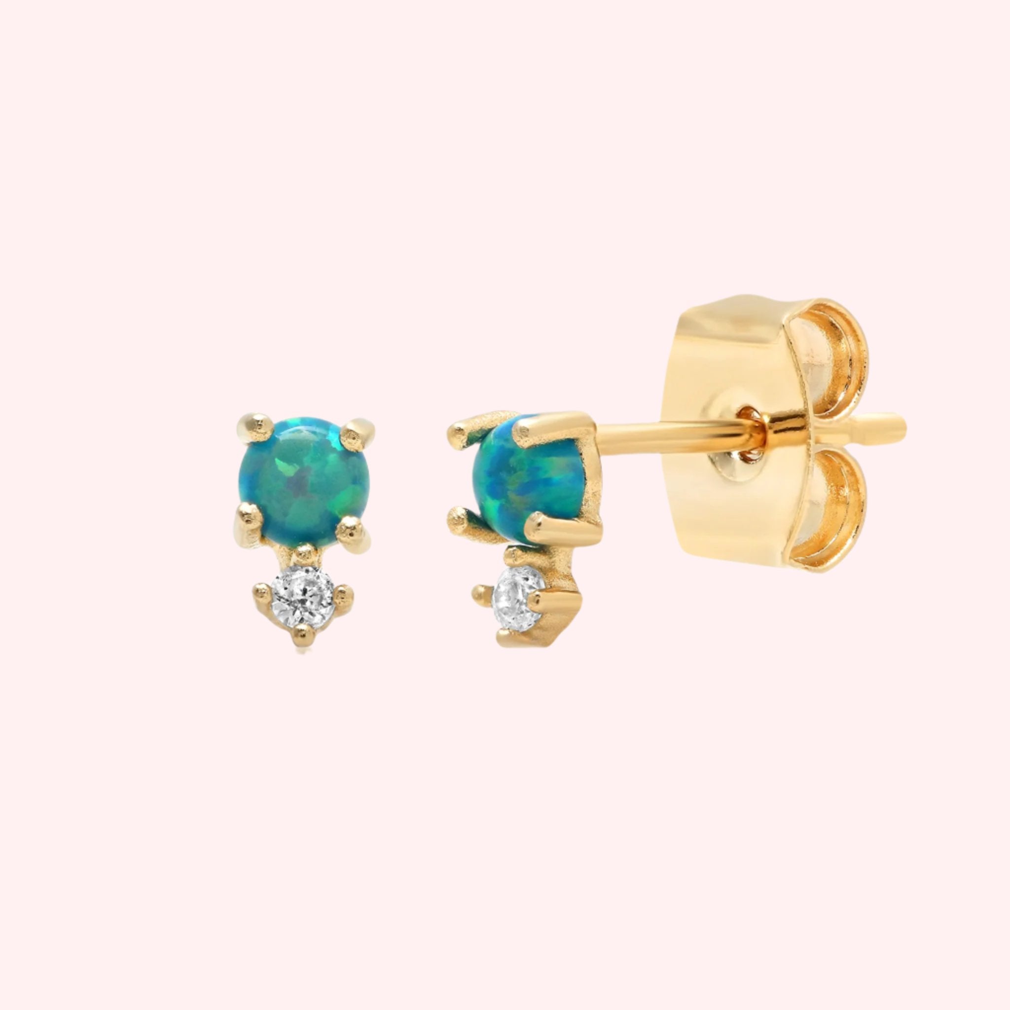 A gold pair of stud earrings with a blue opal stone in the center and a cz stone dangling underneath each. 