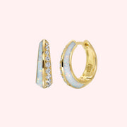 A pair of gold huggie hoop earring with cz stones on one side and opal on the other. 