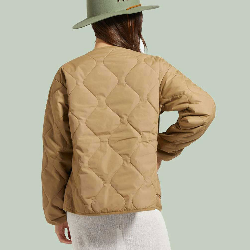 woman wearing light brown quilted jacket