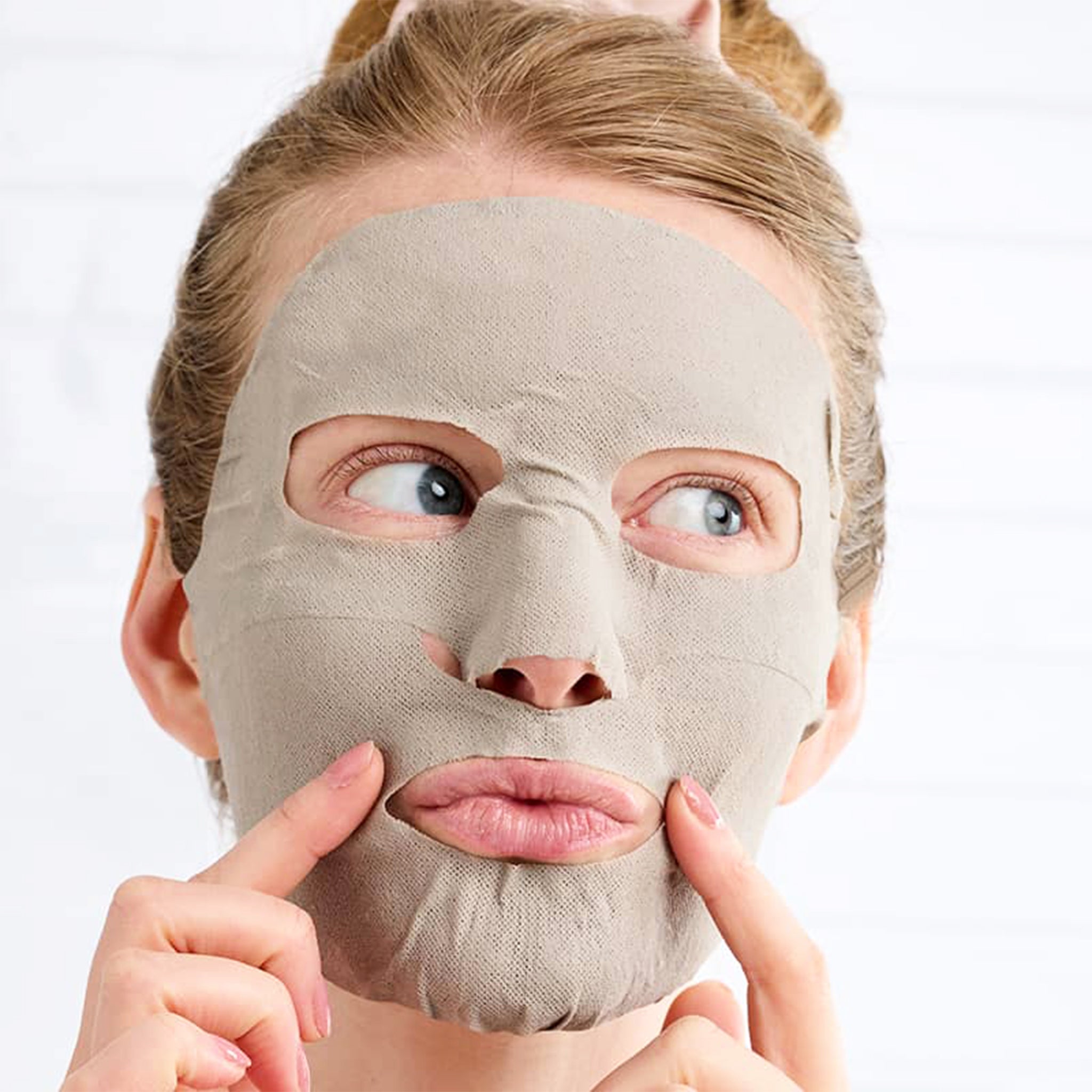 A mud mask made into a sheet mask in a pink two-toned package.