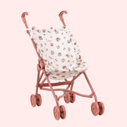 A rosey pink and ivory floral print doll stroller. 