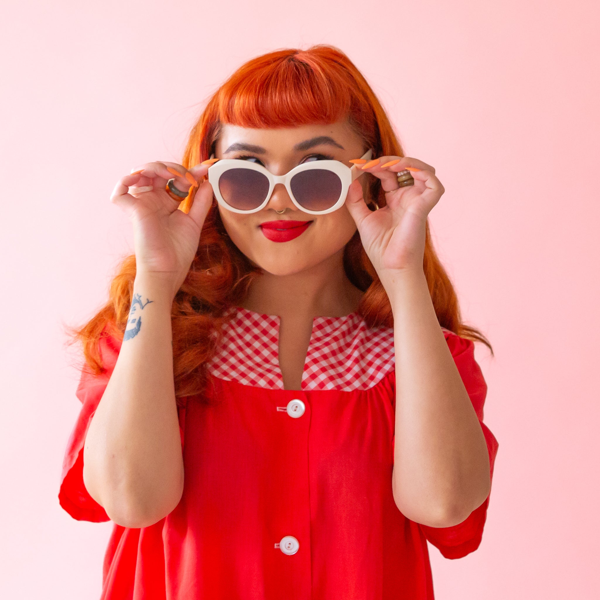 White rounded chunky sunglasses with a brown lens.