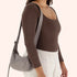 A grey / tan nylon handbag with an adjustable strap to make it a crossbody or a shoulder bag. 