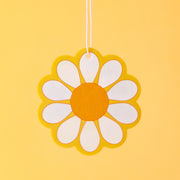 A yellow, white and orange daisy shaped air freshener.