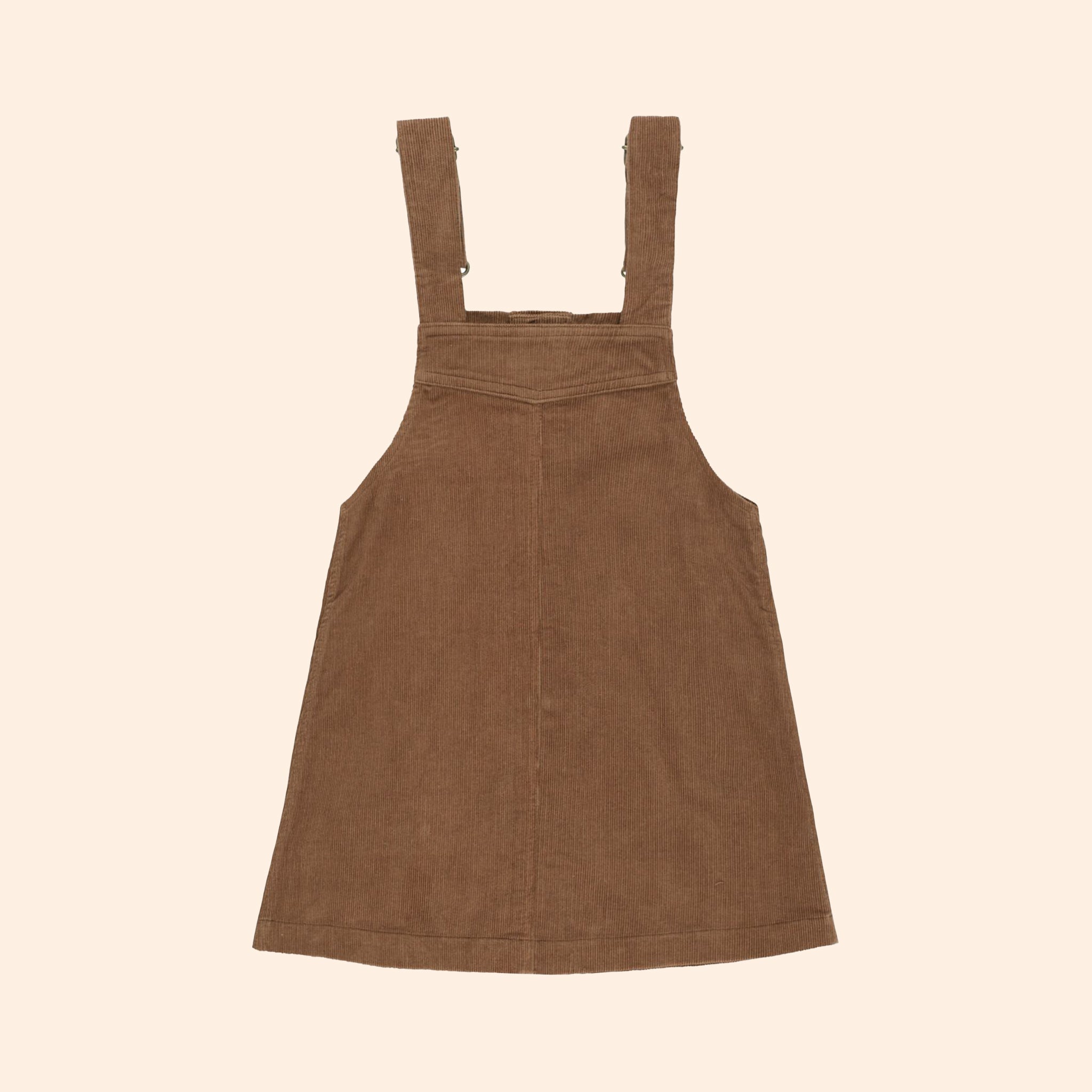 A children's sized brown overall dress with buttons up the front and button shoulder straps.