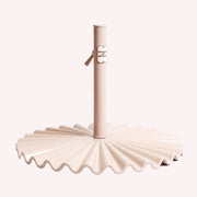 A light pink clamshell umbrella base.