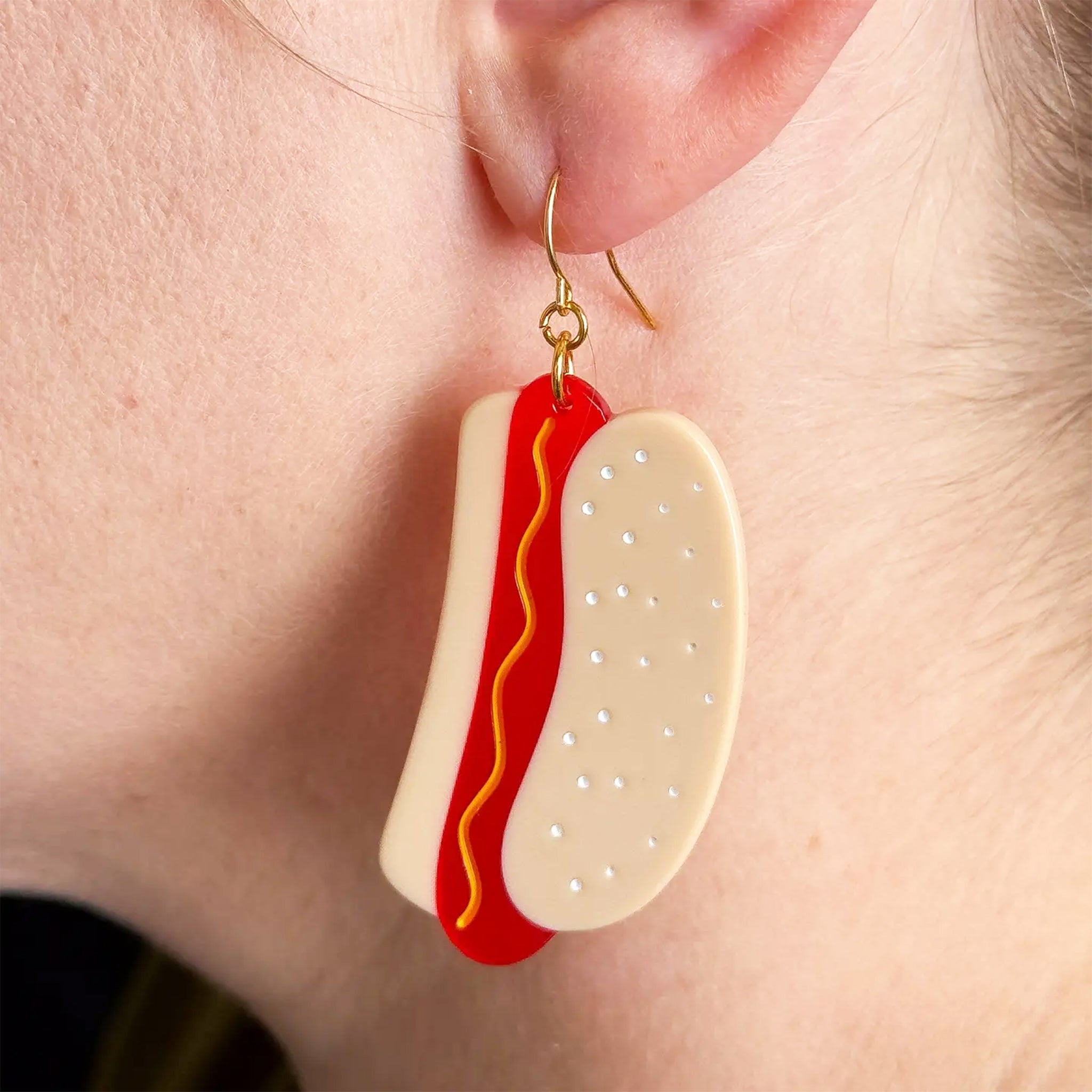 A pair of hot dog shaped earrings. 