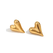 A pair of gold heart shaped earrings. 