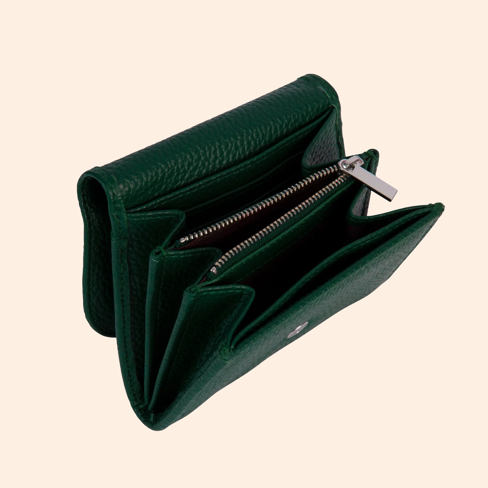 A dark green wallet with a removable crossbody strap. 