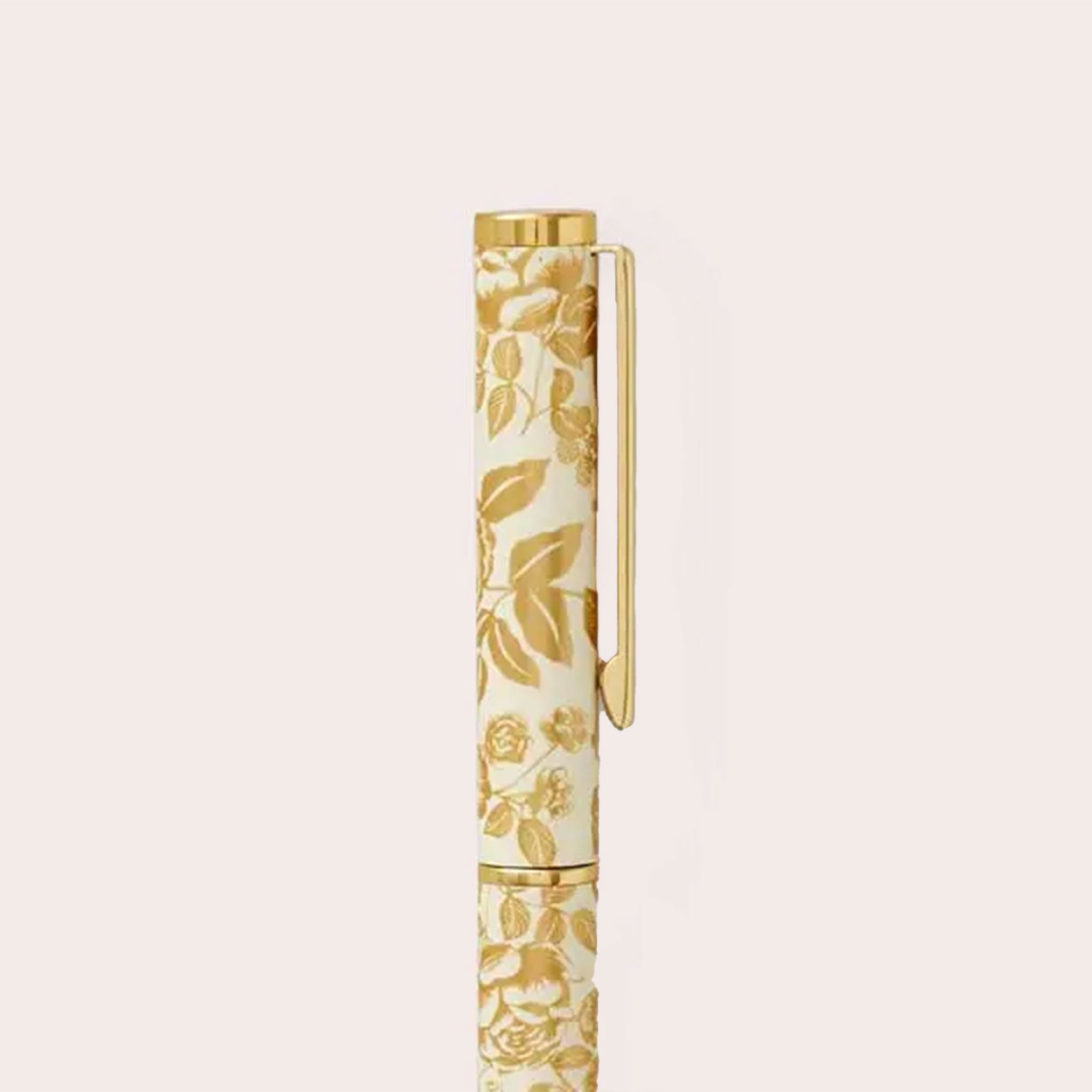 a capped pen with gold flower design