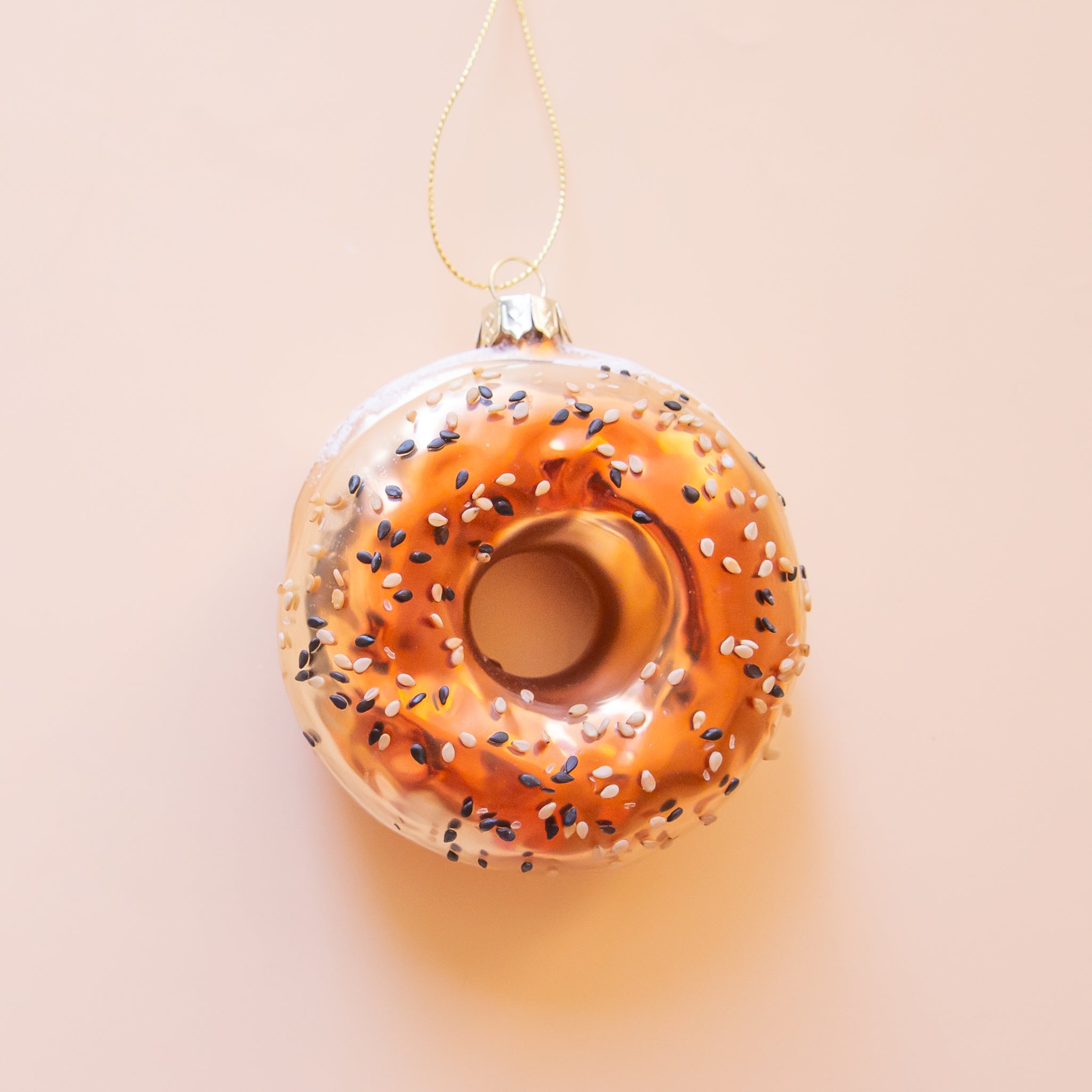 A glass everything bagel shaped ornament. 