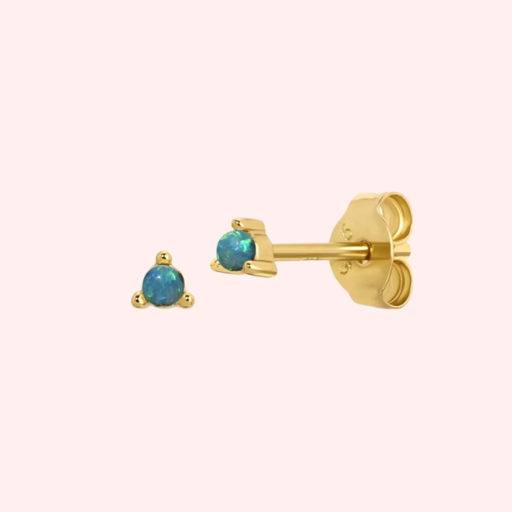 A pair of stud earrings with a three prong opal stone in the center. 