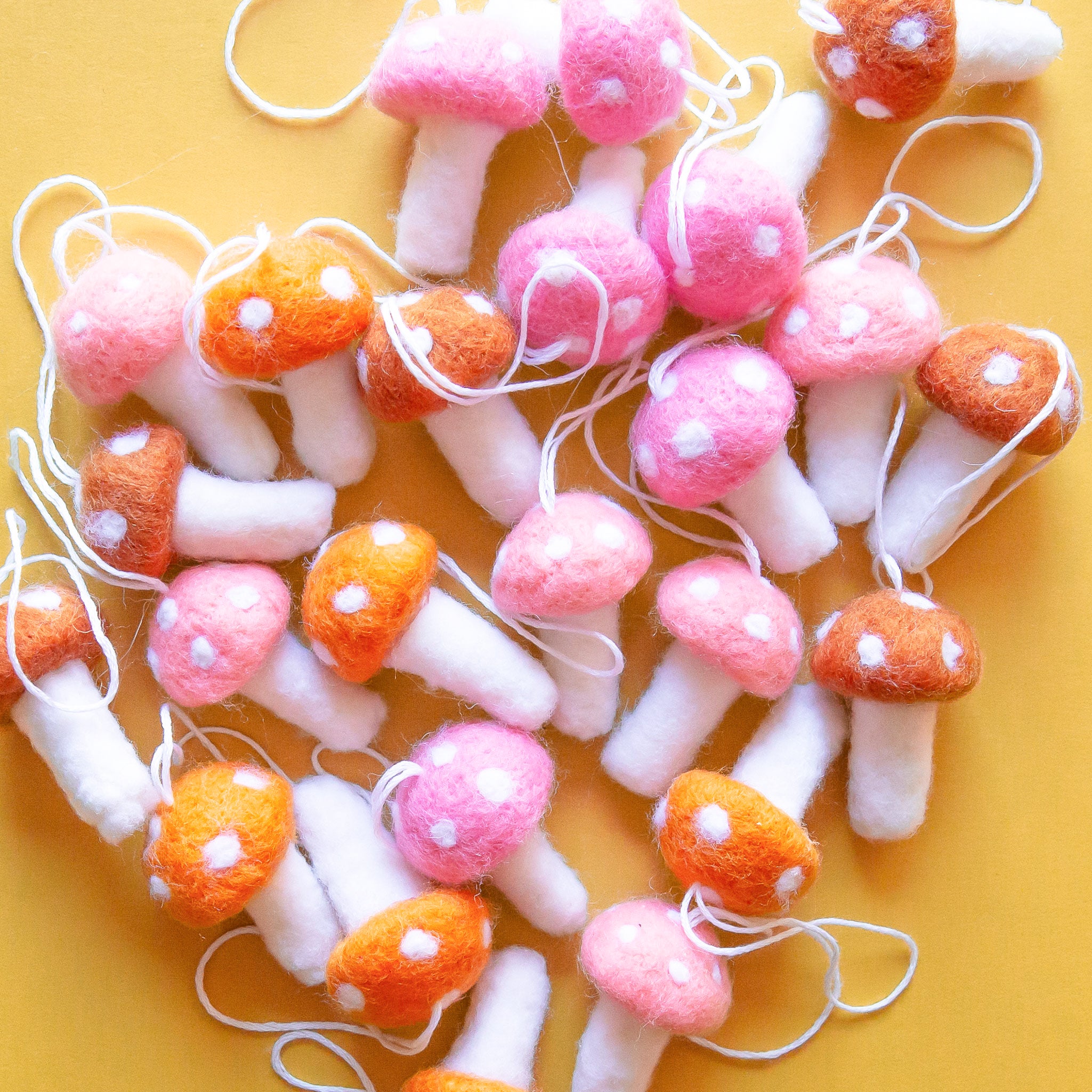 Different colored felt mushroom shaped ornaments. 