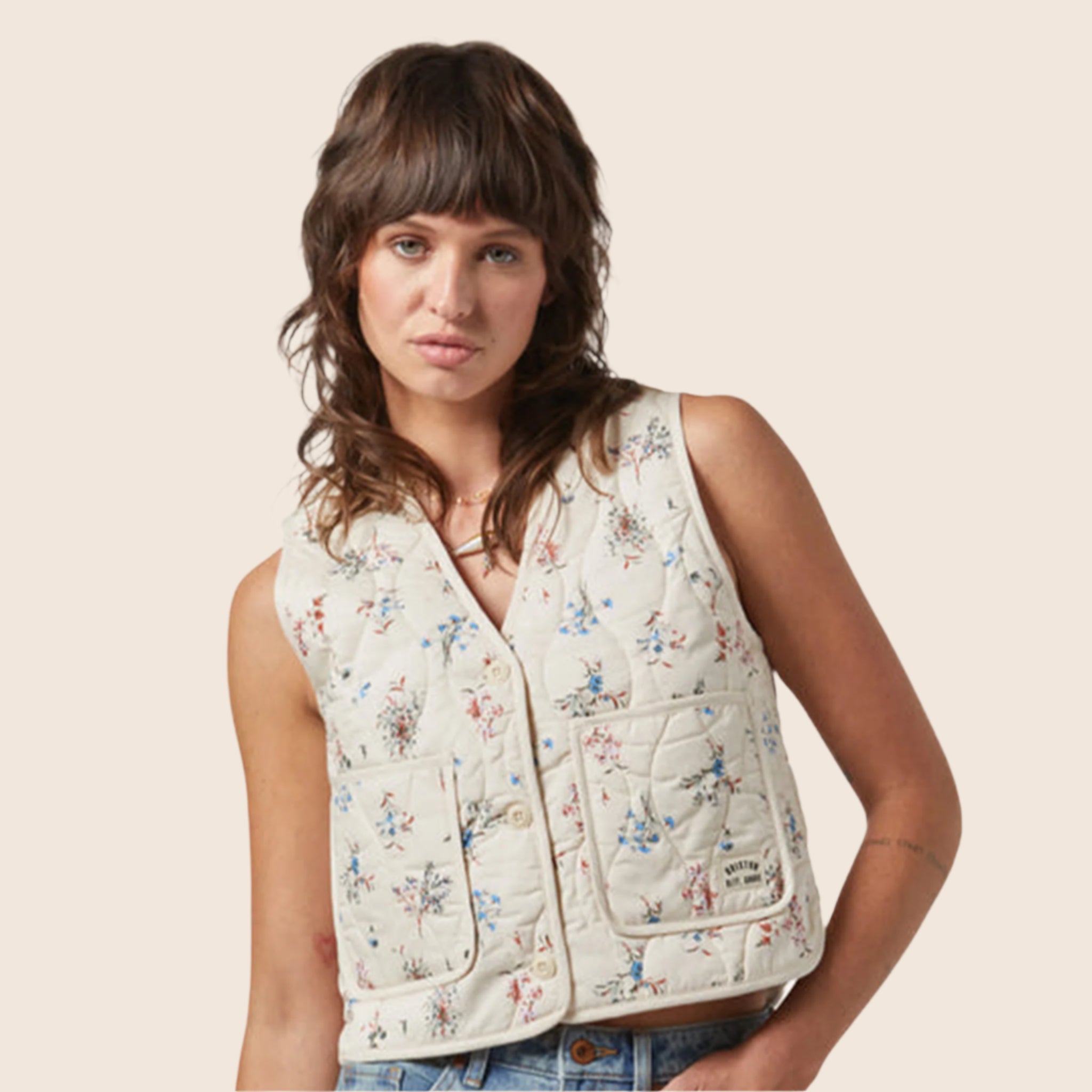 A dainty floral printed quilted button up vest. 