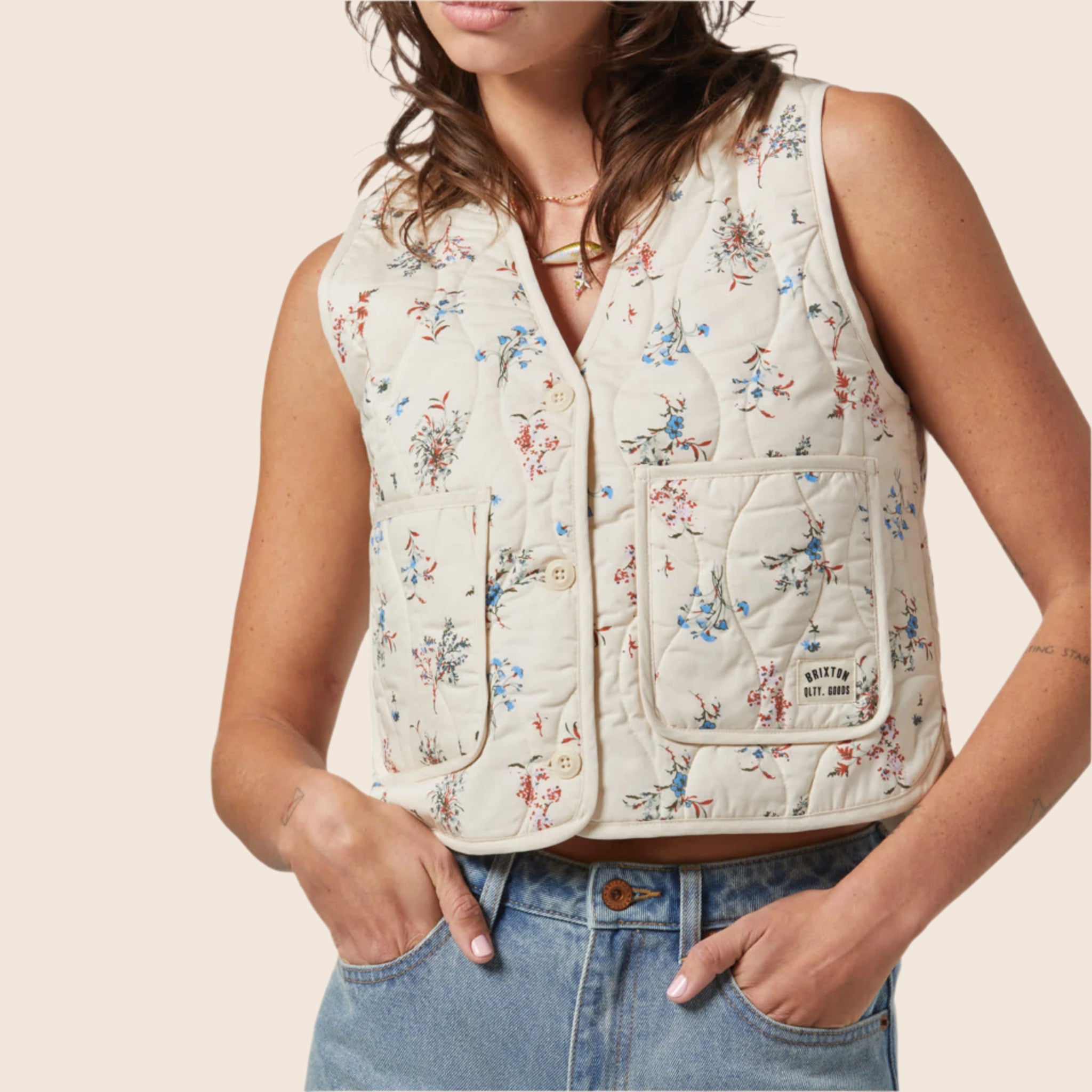 A dainty floral printed quilted button up vest. 