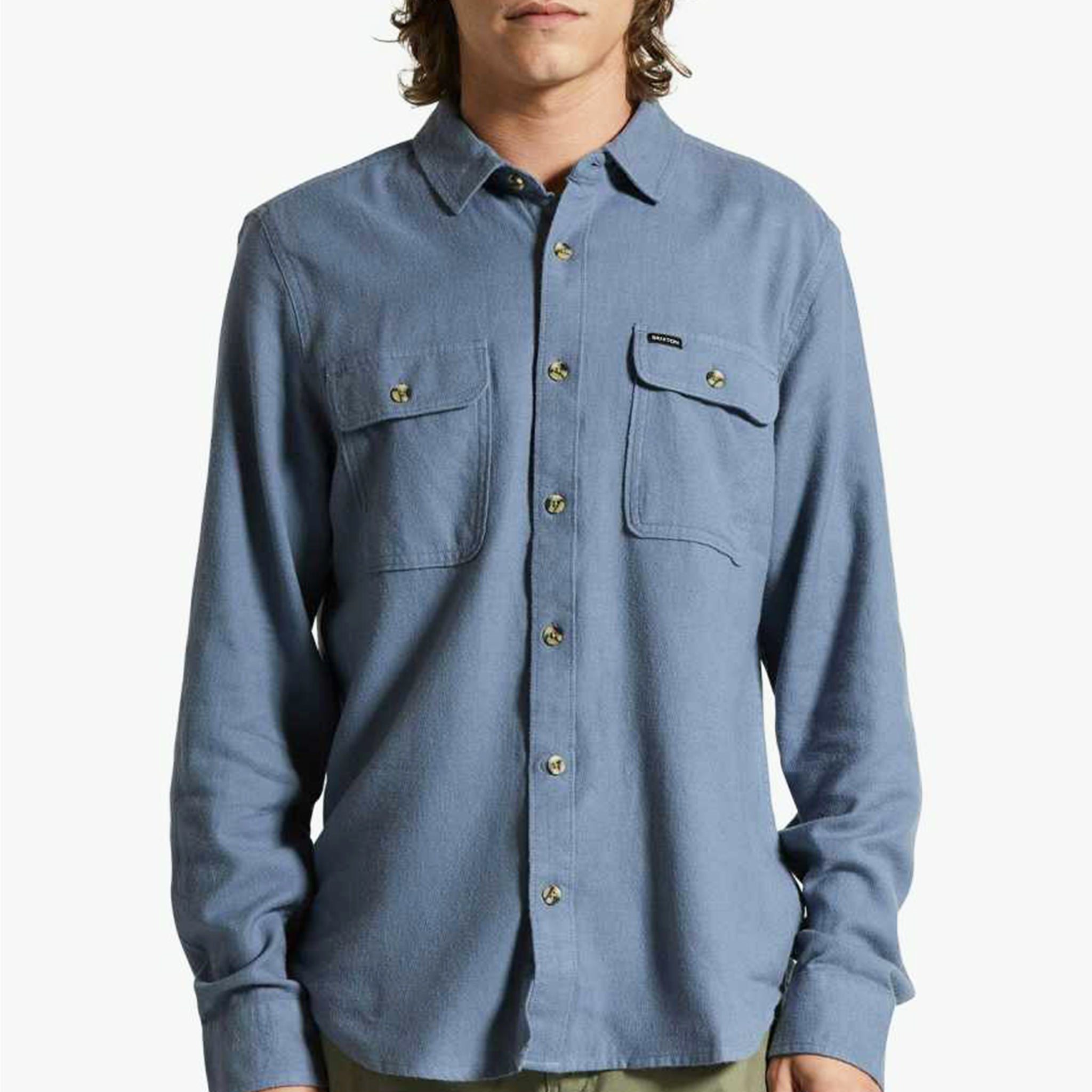 A blue flannel material button up shirt for men with long sleeves and two front pockets.