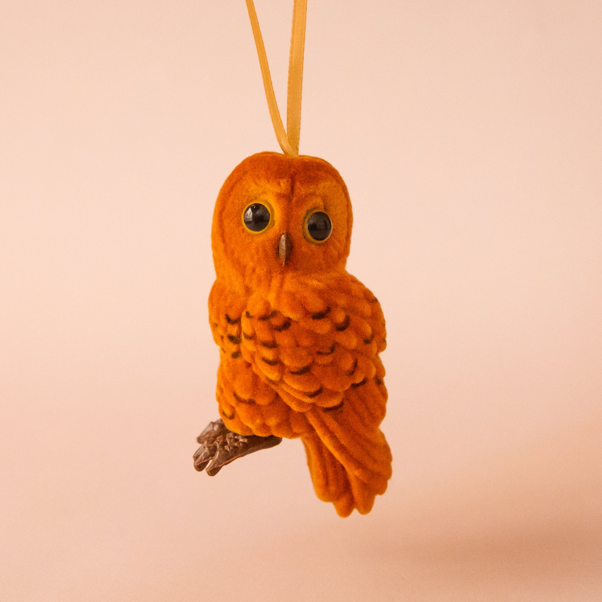 A flocked brown owl shaped ornament.