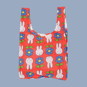 A red nylon bag with a Miffy and flower print. 