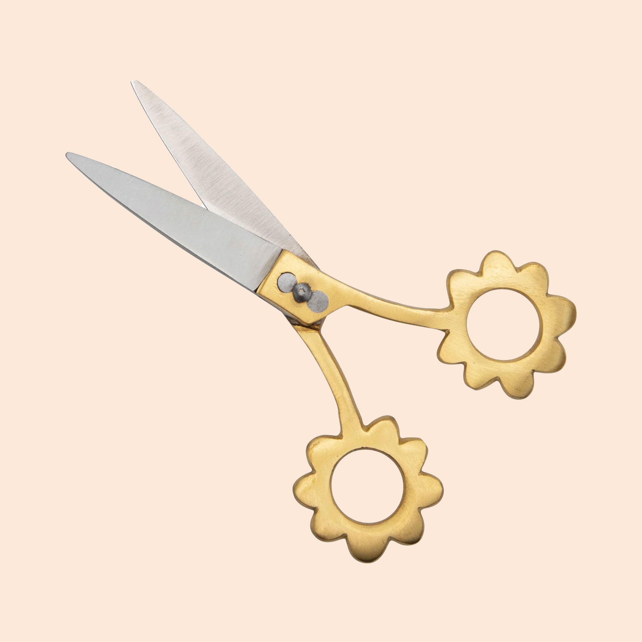 These scissors have stainless steel blades and brass handles. The holes to place your fingers through are in the shape of flowers.