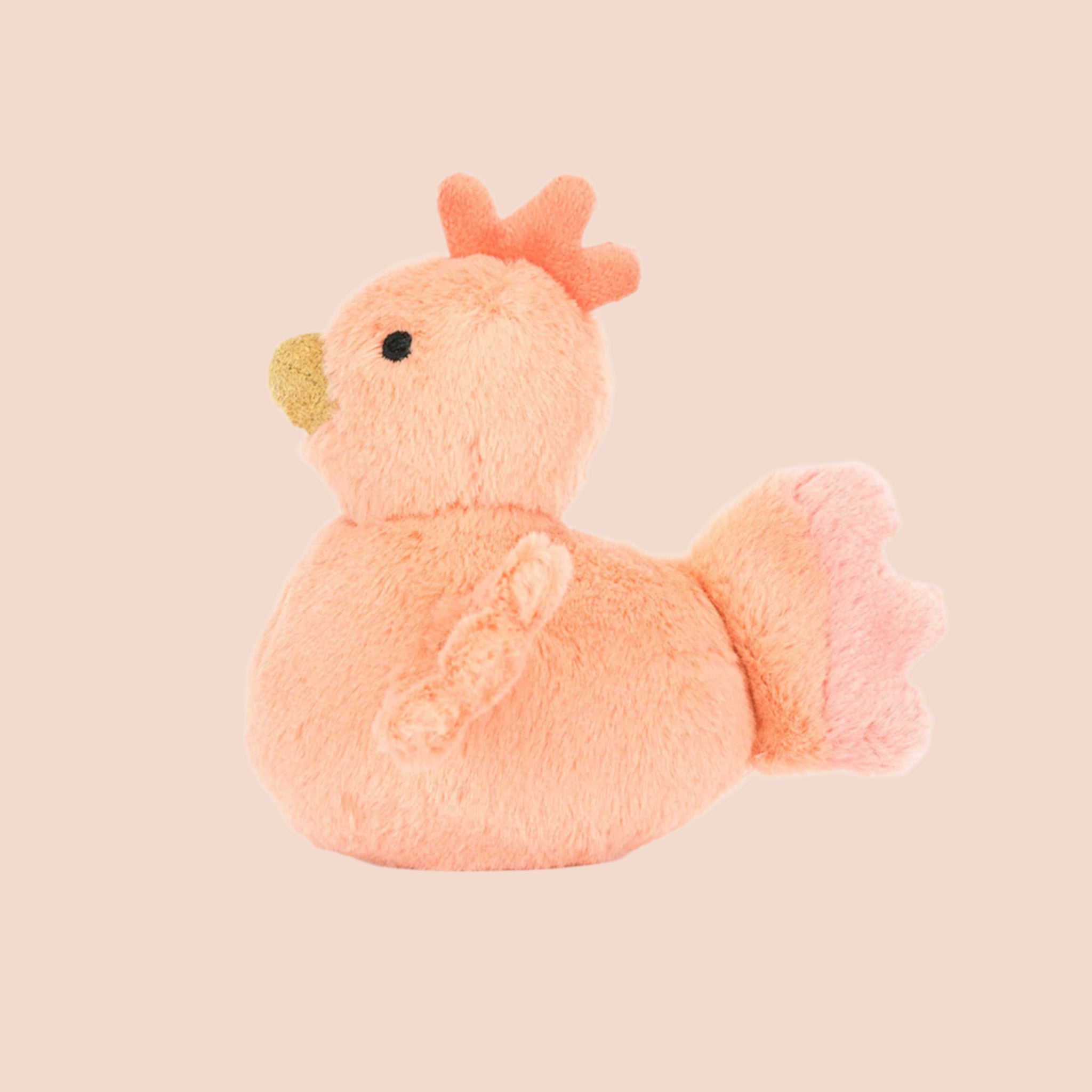 An orange fluffy chicken stuffed animal. 