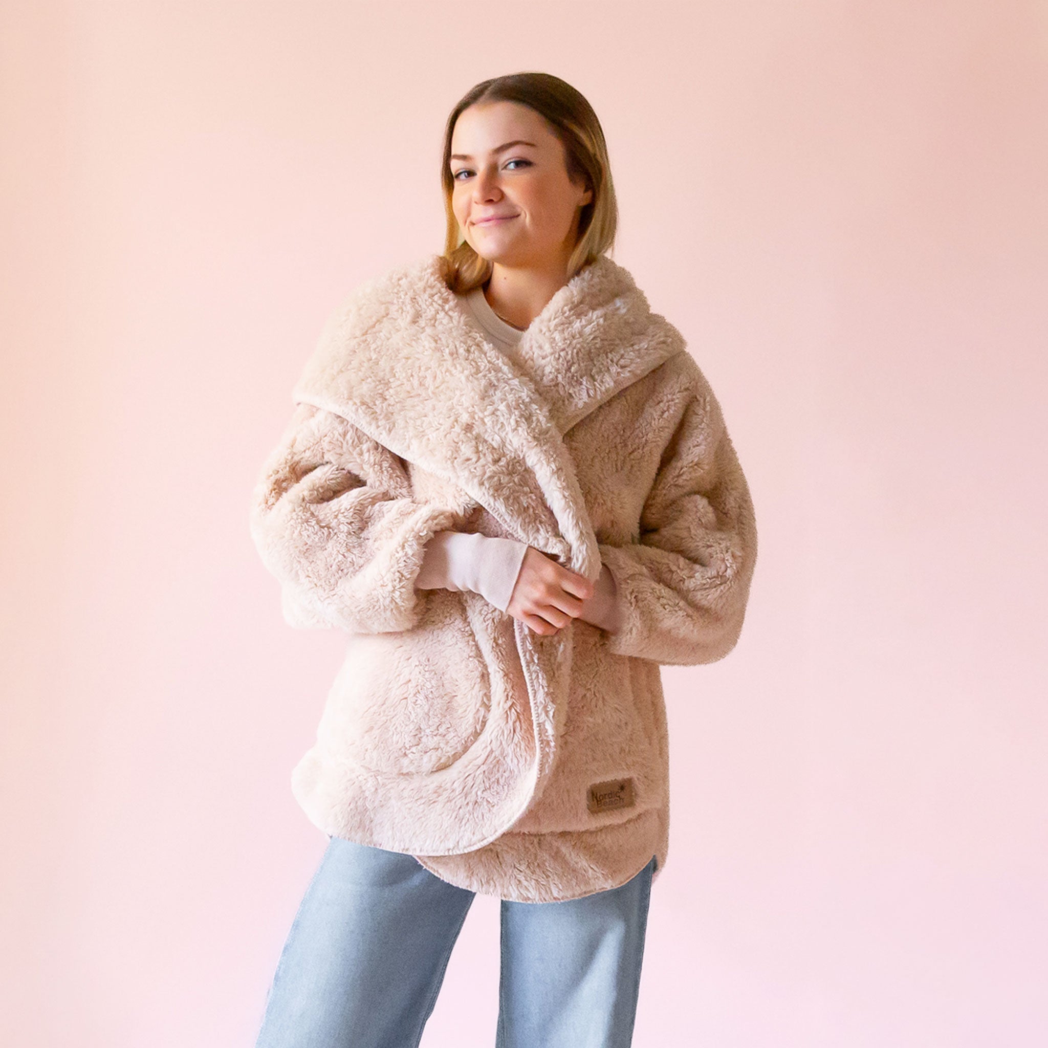 A beige jacket wrap in a fluffy material. 