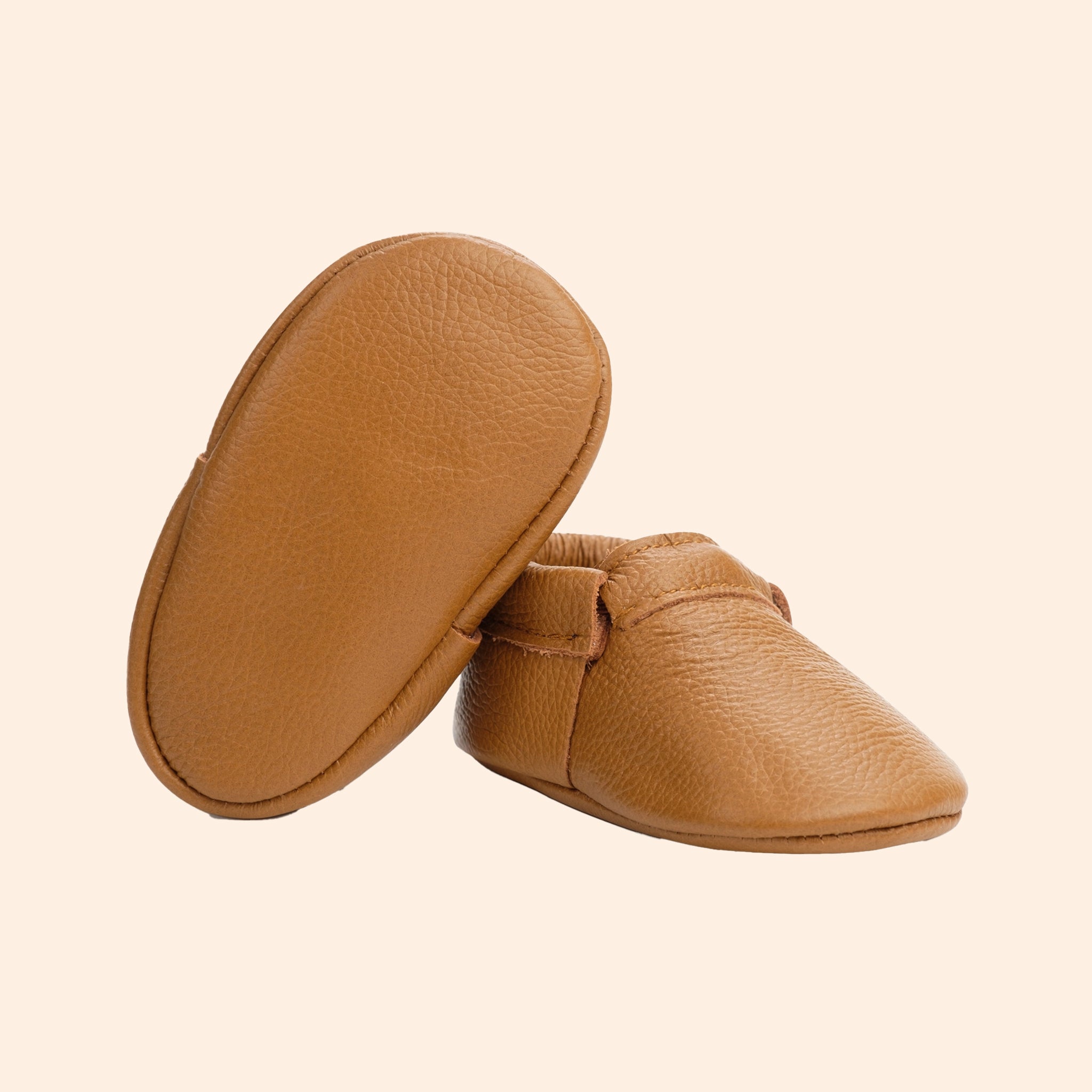 A pair of tan leather moccasins. 