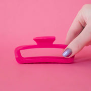 A hot pink rectangle claw clip with rounded edges. 