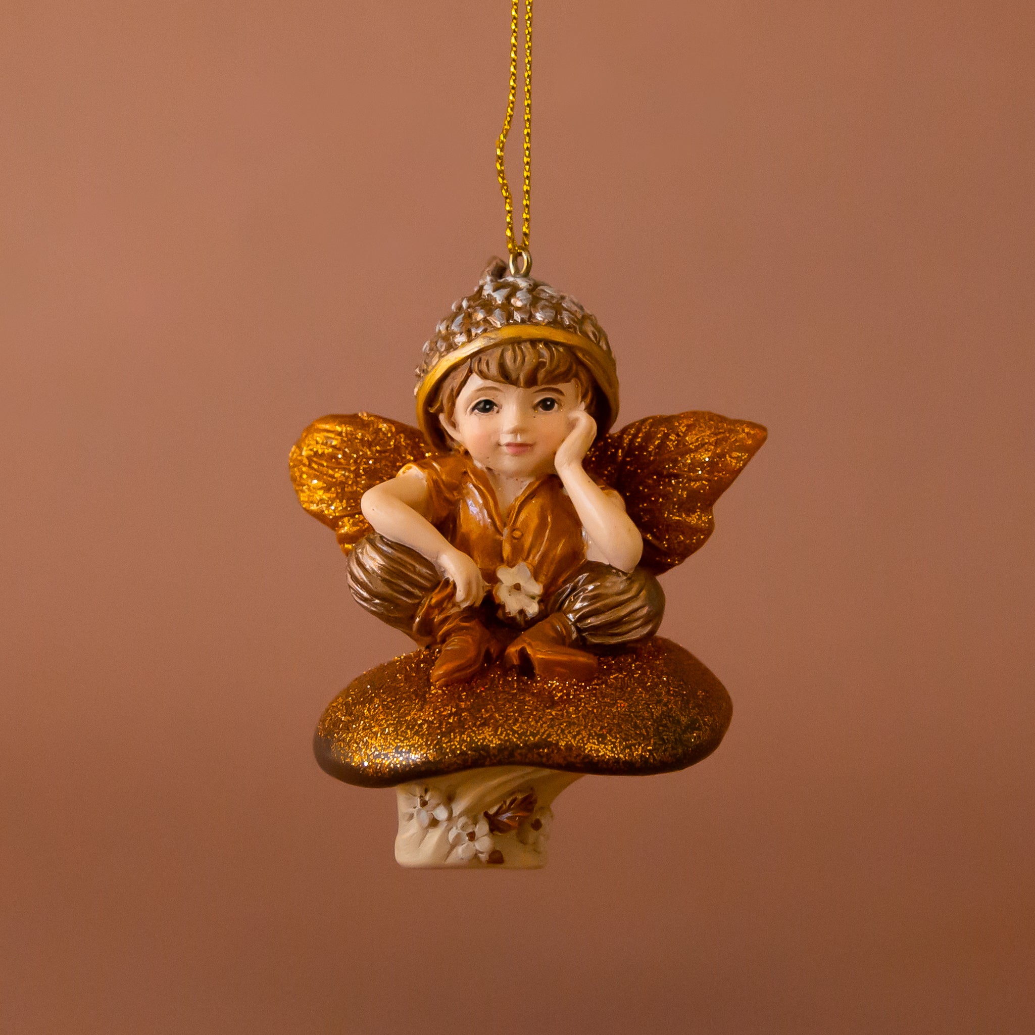 A brown and copper sparkle fairy and mushroom shaped ornament. 