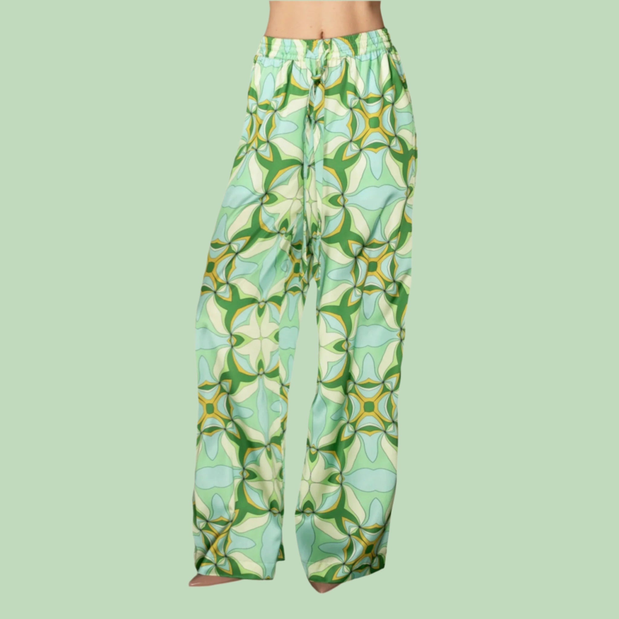 A pair of green retro geometric patterned satin pants with a drawstring.