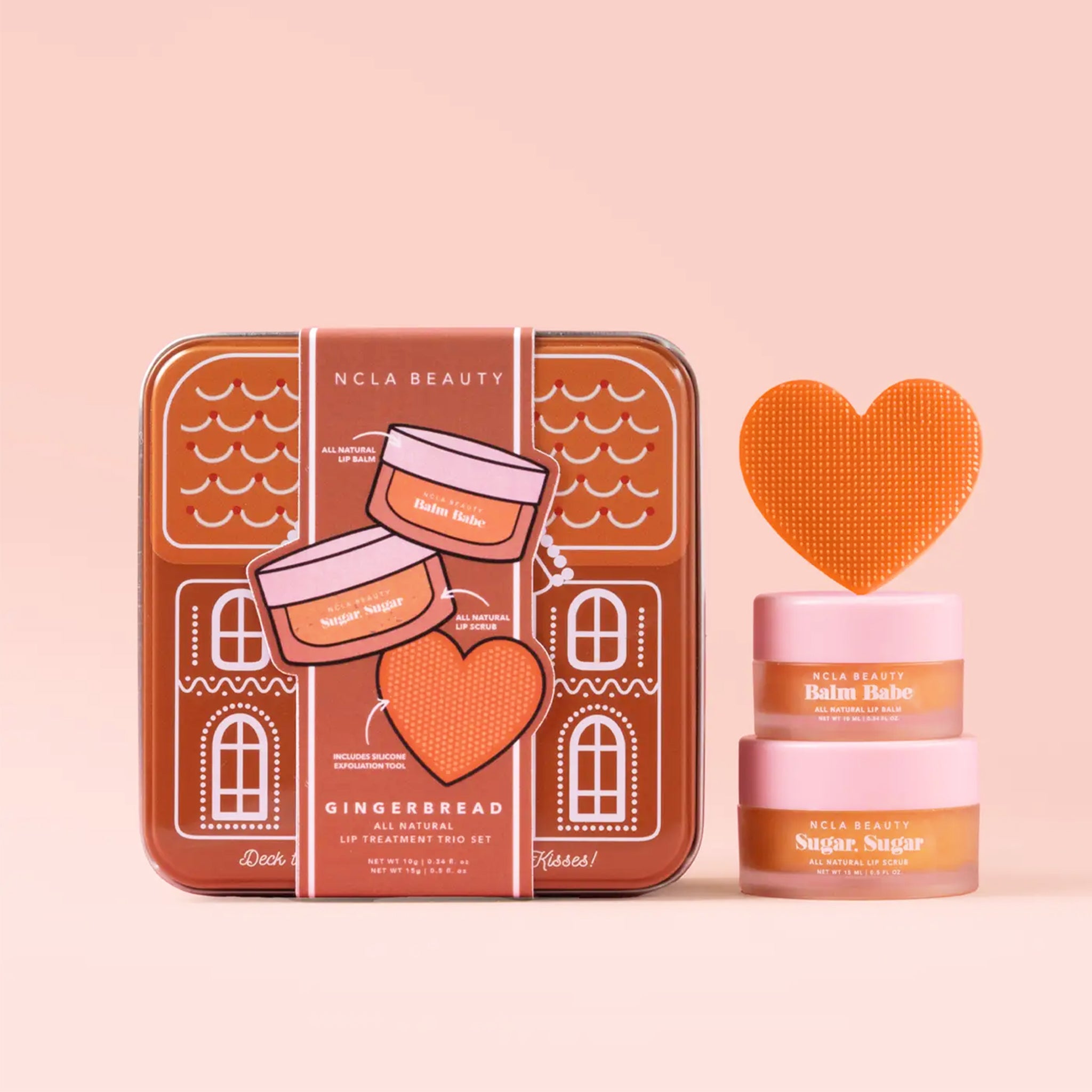 A gingerbread shaped house tin filled with a lip mask, a lip scrub and a silicone heart shaped lip exfoliator. 