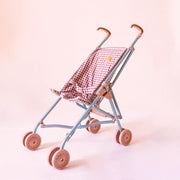 A pink and dark pink gingham printed stroller for dolls with pink wheels. 