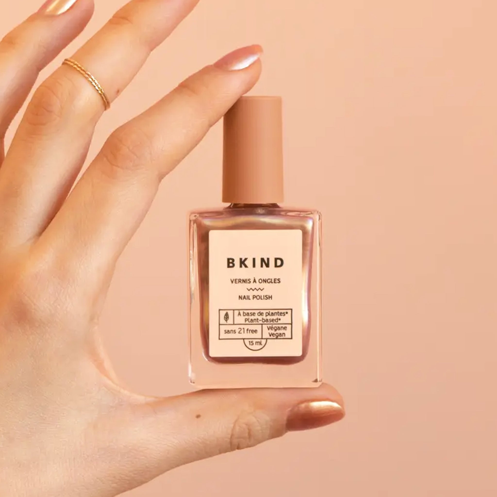 A bottle of rose gold nail polish. 