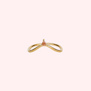 A gold arched ring with a small champagne CZ stone at the top of the arch. 