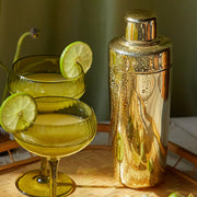 A gold cocktail shaker. 