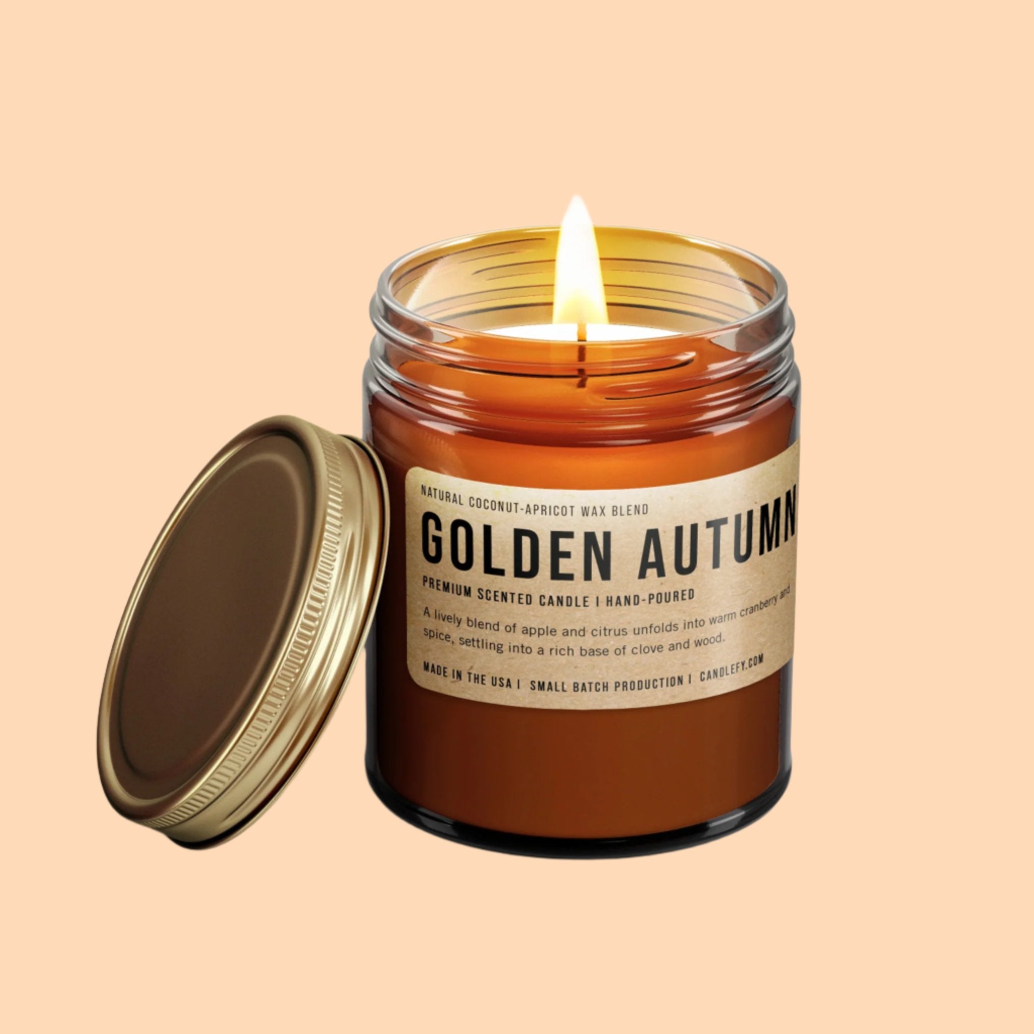 A dark brown glass jar candle with a brown label that reads, 'Golden Autumn'. 