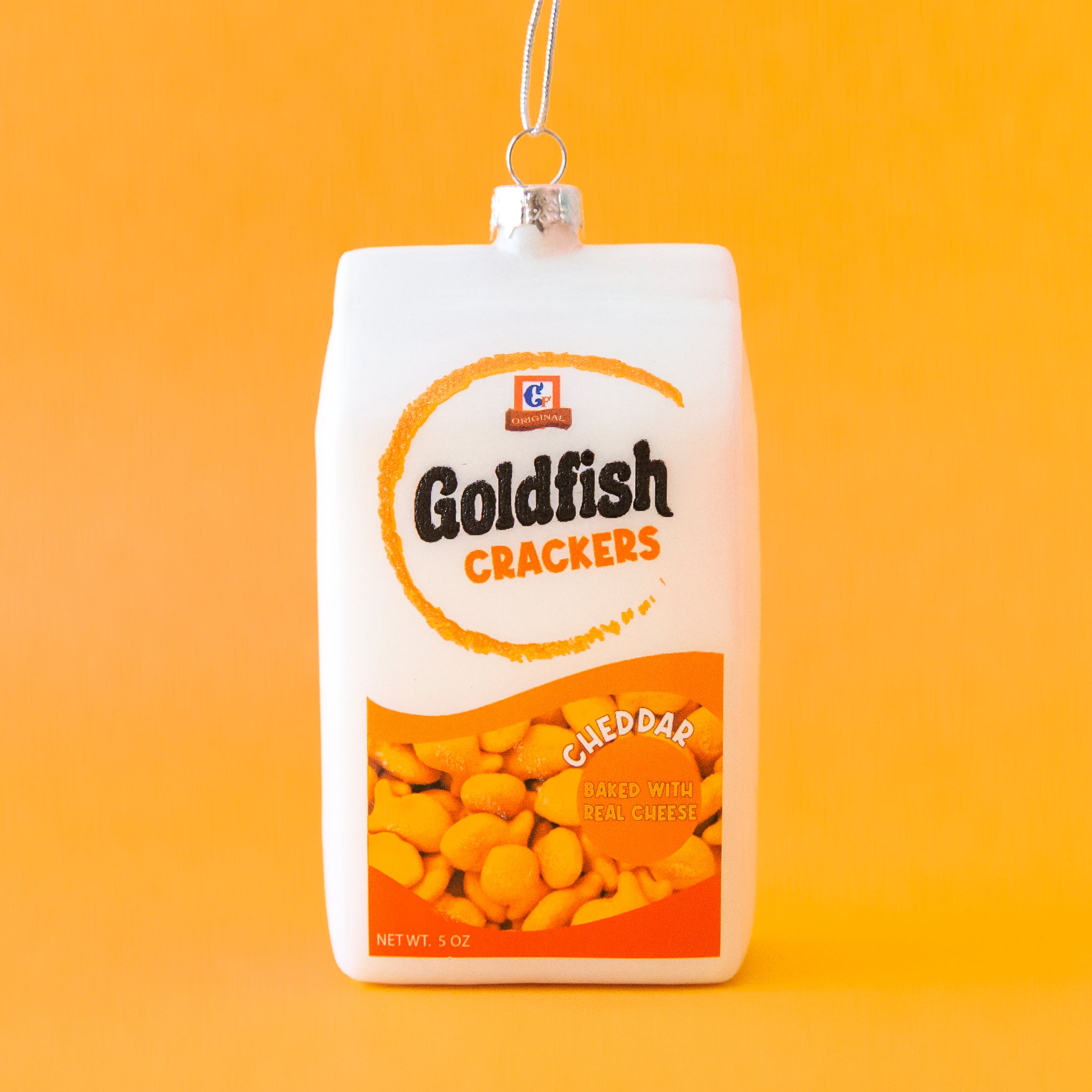 A white goldfish cracker package shaped ornament. 