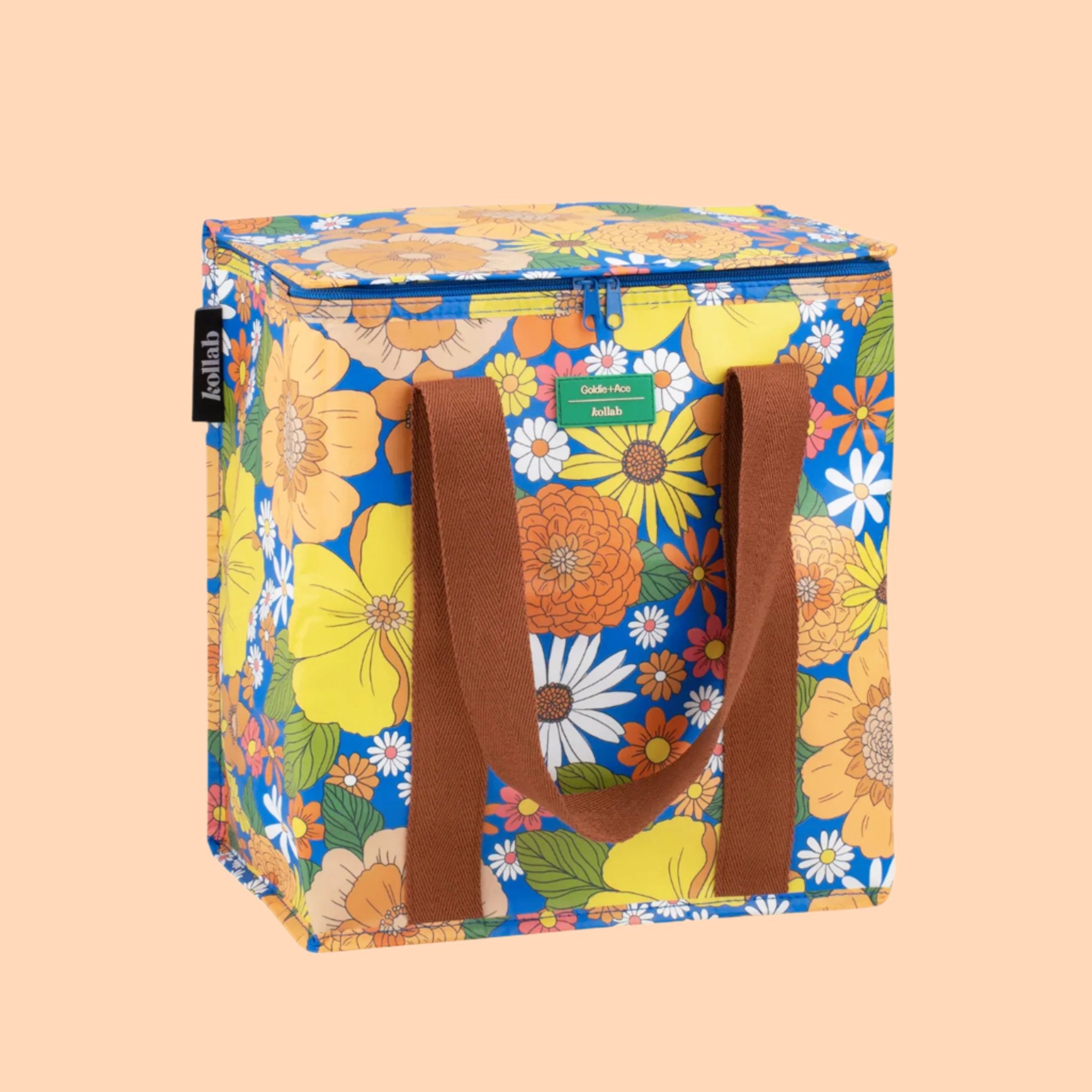 A colorful floral cooler bag with brown canvas handles.  